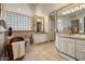 Bright bathroom with a soaking tub, double vanity, and large mirrors for a spa-like experience at 11821 S Tuzigoot Ct, Phoenix, AZ 85044
