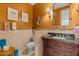 Elegant bathroom featuring decorative tilework, and a vanity with marble countertop and vessel sink at 11821 S Tuzigoot Ct, Phoenix, AZ 85044