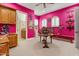 Eclectic bedroom featuring unique decor and bright pink walls with white trim at 11821 S Tuzigoot Ct, Phoenix, AZ 85044