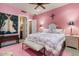 Inviting pink bedroom featuring floral bedding, soft lighting, and a calm ambiance at 11821 S Tuzigoot Ct, Phoenix, AZ 85044