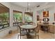 Bright breakfast nook area is surrounded by large windows with views of the lush exterior at 11821 S Tuzigoot Ct, Phoenix, AZ 85044