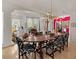 Dining room with large table and chandelier, travertine floors, high ceilings, and open floorplan at 11821 S Tuzigoot Ct, Phoenix, AZ 85044