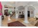 Elegant foyer with soaring ceilings, staircase, travertine floors, and open floor plan at 11821 S Tuzigoot Ct, Phoenix, AZ 85044