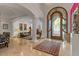 Bright entryway with travertine floors, columns, and large arched window at 11821 S Tuzigoot Ct, Phoenix, AZ 85044