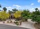 Charming home with lush desert landscaping, a stone mailbox, and circular driveway at 11821 S Tuzigoot Ct, Phoenix, AZ 85044