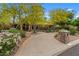 Charming home with a circular driveway, lush landscaping, and an elegant water fountain feature at 11821 S Tuzigoot Ct, Phoenix, AZ 85044