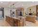 Spacious kitchen boasts a large center island with marble countertop and ample wooden cabinets at 11821 S Tuzigoot Ct, Phoenix, AZ 85044