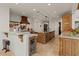 Bright kitchen featuring custom wood cabinetry, stone countertops, and pendant lighting at 11821 S Tuzigoot Ct, Phoenix, AZ 85044