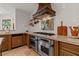 Kitchen featuring stainless steel double ovens, granite countertops, and custom cabinetry at 11821 S Tuzigoot Ct, Phoenix, AZ 85044