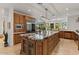 Gourmet kitchen featuring custom cabinets, stainless steel appliances, and large island at 11821 S Tuzigoot Ct, Phoenix, AZ 85044