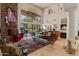 Spacious living room with stone fireplace, large windows, and comfortable seating at 11821 S Tuzigoot Ct, Phoenix, AZ 85044