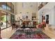 Spacious living room with high ceilings, large windows, and access to the outdoor patio at 11821 S Tuzigoot Ct, Phoenix, AZ 85044