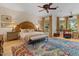 Expansive main bedroom with hardwood floors, ceiling fan and ample natural light from the large windows at 11821 S Tuzigoot Ct, Phoenix, AZ 85044