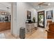 Bright office space with views into kitchen and to the lush exterior landscaping at 11821 S Tuzigoot Ct, Phoenix, AZ 85044