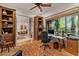 Inviting office space with custom wooden bookshelves and a large window offering pleasant views at 11821 S Tuzigoot Ct, Phoenix, AZ 85044