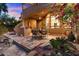 Outdoor dining area with grill, surrounded by lush landscaping and decorative rocks, perfect for entertaining at 11821 S Tuzigoot Ct, Phoenix, AZ 85044