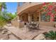 This outdoor kitchen features a built-in barbecue, prep area, and a dining set on a beautifully paved patio at 11821 S Tuzigoot Ct, Phoenix, AZ 85044