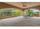 Relaxing outdoor patio with arched openings and views of mature trees at 11821 S Tuzigoot Ct, Phoenix, AZ 85044