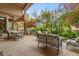 Inviting outdoor patio with comfortable seating and abundant foliage and trees at 11821 S Tuzigoot Ct, Phoenix, AZ 85044
