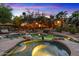 Backyard with a sparkling pool, spa, and lush greenery, creating a serene and inviting outdoor living space at 11821 S Tuzigoot Ct, Phoenix, AZ 85044