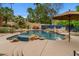 Inviting pool area with rock accents, a waterfall feature, and a spacious patio, offering a perfect outdoor retreat at 11821 S Tuzigoot Ct, Phoenix, AZ 85044