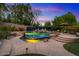 Inviting pool featuring mosaic tile and mature trees for privacy in this backyard oasis with lounge chairs at 11821 S Tuzigoot Ct, Phoenix, AZ 85044