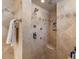 Walk-in shower featuring dual shower heads, tile surround, and built-in bench at 11821 S Tuzigoot Ct, Phoenix, AZ 85044