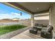 Spacious backyard with a covered patio, a trampoline, an artificial grass area and a block wall at 12374 W Locust Ln, Avondale, AZ 85323