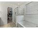 A bathroom features a glass-enclosed shower, bathtub, and walk-in closet at 12374 W Locust Ln, Avondale, AZ 85323