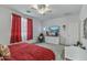 A large bedroom features a ceiling fan, TV, and gaming chair at 12374 W Locust Ln, Avondale, AZ 85323