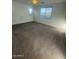 An empty bedroom shows neutral-colored carpet and three windows at 12374 W Locust Ln, Avondale, AZ 85323