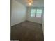 This bedroom features neutral walls and carpet, with windows offering natural light at 12374 W Locust Ln, Avondale, AZ 85323