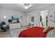 A large bedroom features a ceiling fan, TV, and gaming chair at 12374 W Locust Ln, Avondale, AZ 85323
