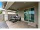 Inviting covered patio with comfortable seating, a coffee table, and a sliding glass door leading indoors at 12374 W Locust Ln, Avondale, AZ 85323