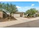 Charming single-story home with a well-maintained front yard and a two-car garage at 12374 W Locust Ln, Avondale, AZ 85323