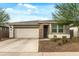 Charming single-story home with a well-maintained front yard and a two-car garage at 12374 W Locust Ln, Avondale, AZ 85323