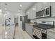 Bright kitchen with granite countertops, stainless steel appliances, and well-organized pantry space for easy storage at 12374 W Locust Ln, Avondale, AZ 85323