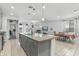 Open floor plan showcases the granite island, stainless sink, and views of the living and dining areas at 12374 W Locust Ln, Avondale, AZ 85323