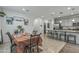 Open-concept kitchen and dining area showcases modern cabinetry, granite counters, and stainless steel appliances at 12374 W Locust Ln, Avondale, AZ 85323