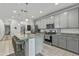 Modern kitchen with an island and stainless steel appliances, complemented by granite countertops and ample storage at 12374 W Locust Ln, Avondale, AZ 85323