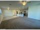Spacious living room and kitchen area with plush carpeting and modern appliances at 12374 W Locust Ln, Avondale, AZ 85323