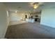 Spacious living room and kitchen area with plush carpeting and modern appliances at 12374 W Locust Ln, Avondale, AZ 85323