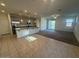 Open floor plan featuring tile flooring in kitchen/dining area and plush carpet in living room at 12374 W Locust Ln, Avondale, AZ 85323