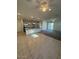 Open floor plan featuring tile flooring in kitchen/dining area and plush carpet in living room at 12374 W Locust Ln, Avondale, AZ 85323