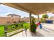 Spacious backyard showcasing a patio, lush green turf, a well-maintained garden, and outdoor play area for  at 12425 W Willow Ave, El Mirage, AZ 85335