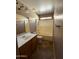 Neutral bathroom with a tub and shower combination, vanity with a sink, and tile flooring at 12425 W Willow Ave, El Mirage, AZ 85335