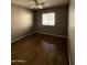 Bedroom with window, neutral walls, and wood-look flooring at 12425 W Willow Ave, El Mirage, AZ 85335