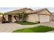 Inviting single-story home showcasing desert landscaping, a two-car garage, and a welcoming entrance at 12425 W Willow Ave, El Mirage, AZ 85335