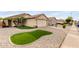 Attractive single-story home featuring desert landscaping, a two-car garage, and a well-maintained lawn at 12425 W Willow Ave, El Mirage, AZ 85335