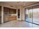 This entertainment area features a sink, built-in microwave and cabinetry, with sliding glass doors at 12711 N 117Th St, Scottsdale, AZ 85259